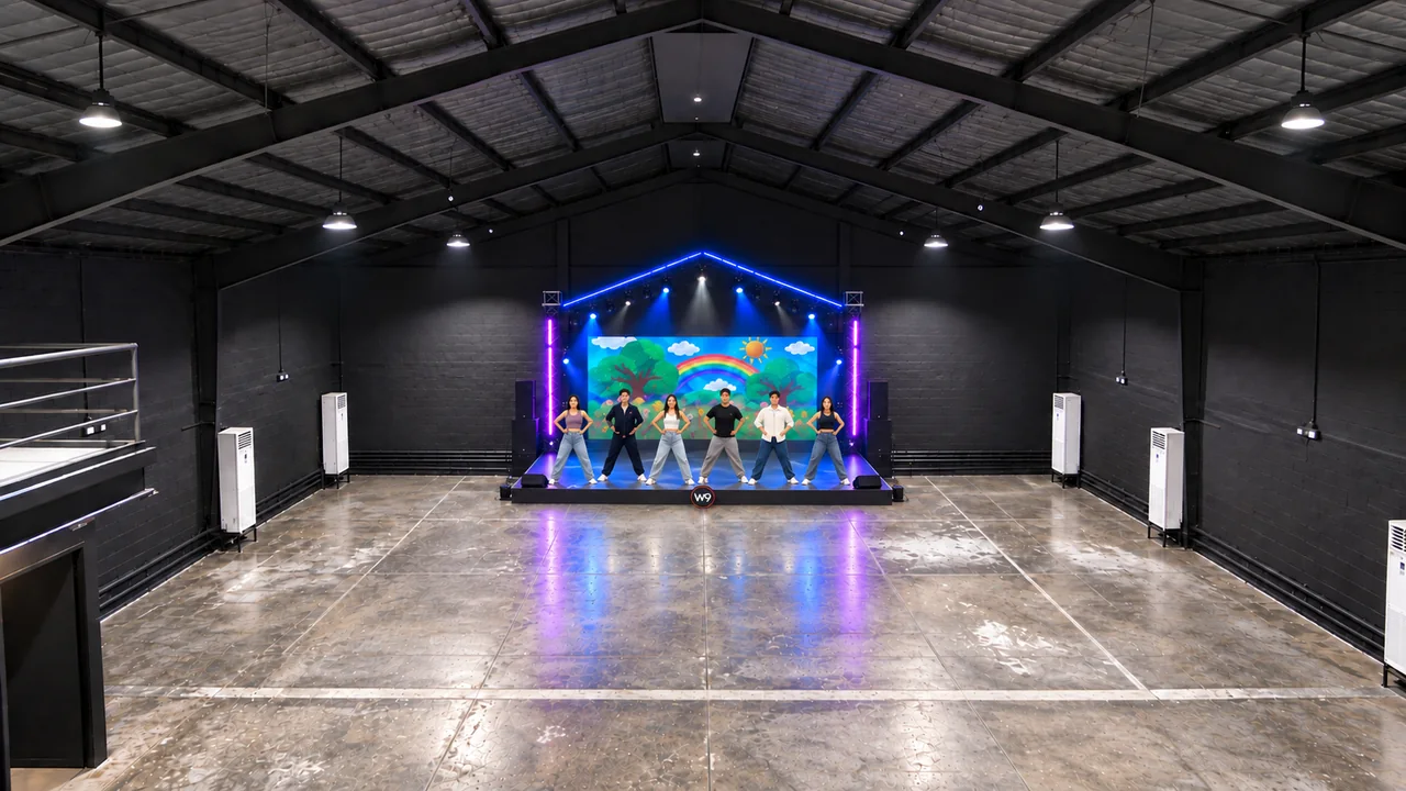 Concept visualization: Performance concept with a compact rainbow LED stage and scaled dancers beneath a blue portal aligned with W9’s roof pitch.